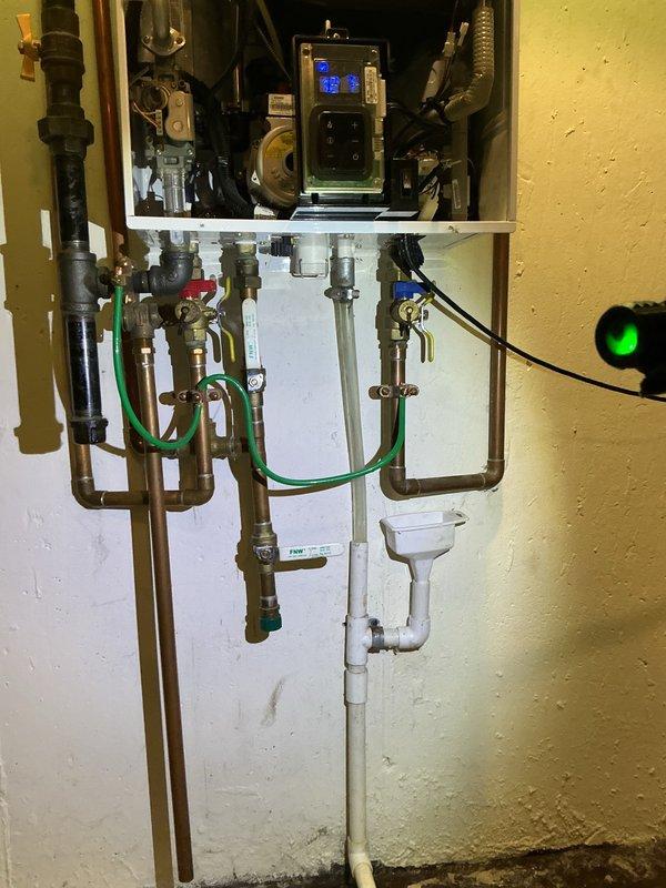 Completed comprehensive tune-up and maintenance service on a multi-system HVAC setup consisting of two furnaces and one tankless water heater. Performed thorough inspection of both furnace combustion chambers, verified proper flame characteristics and burner operation, checked all electrical connections, and tested safety controls. Inspected tankless water heater installation including copper supply lines, isolation valves, condensate drain system, control board operation with digital display, and verified proper venting and circulation pump function.