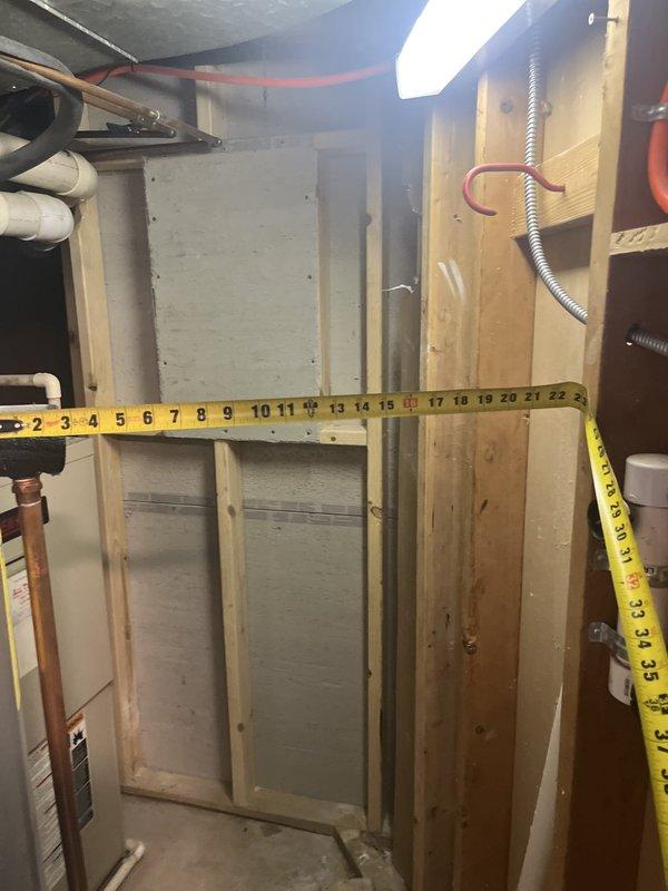 Conducted on-site evaluation for complete HVAC system replacement at residential property. Assessed existing outdoor condenser unit positioned on grade-level stone base against exterior wall and evaluated basement furnace installation within existing utility space. Performed measurements of available clearances and documented current equipment configuration, ductwork connections, and utility routing including gas lines, electrical service, and condensate drainage to prepare comprehensive replacement quote for new air conditioning and heating system.