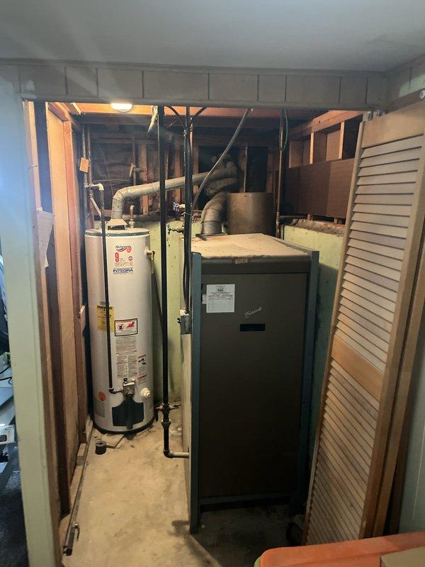 Conducted on-site assessment for boiler and water heater replacement in residential basement mechanical room. Evaluated existing 65-year-old boiler system currently in operational condition and inspected standard water heater unit for potential replacement. Documented equipment specifications, existing piping configurations, and installation requirements to provide comprehensive replacement estimate for both heating and domestic hot water systems.