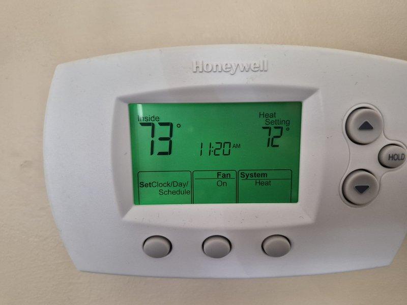 Completed fall commercial preventative maintenance on HVAC system. Confirmed tenant availability prior to service, performed comprehensive checklist inspection of furnace/air handler unit, verified thermostat operation showing 73°F inside temperature with heat set to 72°F, documented equipment information and filter specifications, and captured photos of unit and thermostat for service records.