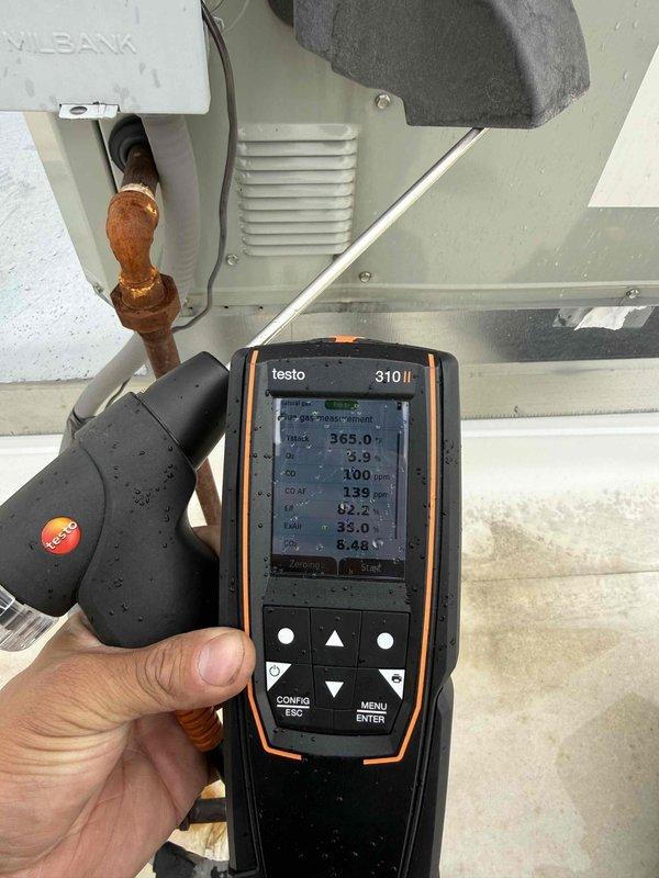 Completed fall commercial preventative maintenance on HVAC unit per contract specifications. Confirmed tenant availability prior to service, performed comprehensive checklist inspection including electrical measurements with clamp meter showing 7.108 amp draw, and conducted combustion analysis using Testo 310 II analyzer with readings of 365.0°F stack temperature, 100 ppm and 139 ppm gas measurements. Inspected capacitor, wiring harness, and internal components through access panel. Documented equipment information and filter specifications for records, noting corroded copper piping that may require future attention. Updated equipment data and flagged necessary filter list changes for system tracking.