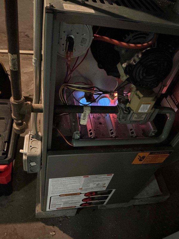 Completed comprehensive clean and check maintenance service on basement furnace system under comfort plan agreement. Performed thorough inspection of heat exchanger assembly, burner components, blower motor with blue housing, gas valve assembly, and all electrical connections. Verified proper operation of all safety controls, sensors, and ignition components. Cleaned accessible components, checked gas piping connections, and confirmed system is operating within manufacturer specifications. All components functioning properly with no immediate concerns noted. System ready for heating season.
