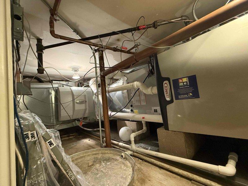 Completed Gold Clean and Check for heating system as part of recurring maintenance plan. Inspected and serviced HVAC equipment in mechanical room, including air handler unit with associated PVC condensate drainage lines, verified proper operation of all components, and documented equipment condition with photographic records. All systems found operating within normal parameters with condensate drain lines properly secured and functional.