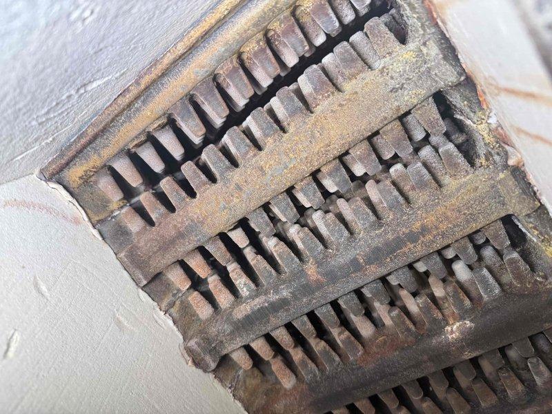 Completed comprehensive tune-up and inspection on boiler heating system. Performed thorough examination of heat exchanger, burner assembly, and ventilation components. Documented equipment condition through photographic inspection, noting exterior vent grate showing weathering and oxidation consistent with age, and internal heat exchanger fins displaying normal dust accumulation. All critical components assessed for proper operation and safety compliance.