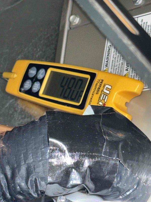 Responded to service call at commercial dance studio for HVAC unit running with minimal airflow and frozen coils. Upon inspection, utilized digital diagnostic meter to assess system performance and refrigerant levels, recording reading of 490R. Examined evaporator coil assembly and ductwork connections in mechanical compartment. System was recently installed this year, requiring thorough evaluation to determine if issue was installation-related or caused by other factors. Documented equipment condition with photos showing measurement readings and component configuration for warranty consideration and follow-up analysis.