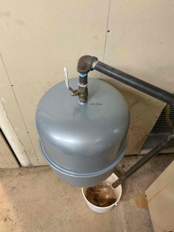Replaced failed expansion tank on hydronic heating system. Removed old corroded unit showing significant rust on pipe fittings and connections, installed new expansion tank with proper pressure gauge and verified system pressure within manufacturer specifications. Documented installation with photos showing completed work and proper gauge readings.
