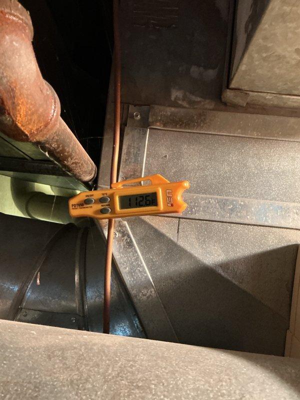 Performed a tune-up on one furnace system, including a borescope inspection of the flexible ductwork and interior components to check for damage, restrictions, and wear. Measured supply air temperature with a digital thermometer, recording 112.6°F at the ductwork, and noted heavy corrosion on an adjacent iron pipe along with dust and cobweb buildup in the mechanical area.