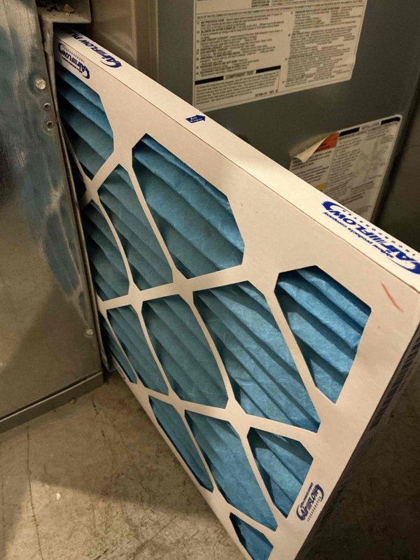 Performed scheduled prepaid commercial maintenance on the furnace/air handler, including inspection of the air filter and flame sensor assembly. Replaced the air filter with a new pleated unit, noting filter size and equipment information for the filter list update. Removed and inspected the flame sensor, which showed dull, tarnished buildup along the rod, and serviced it to support reliable ignition and flame proving.