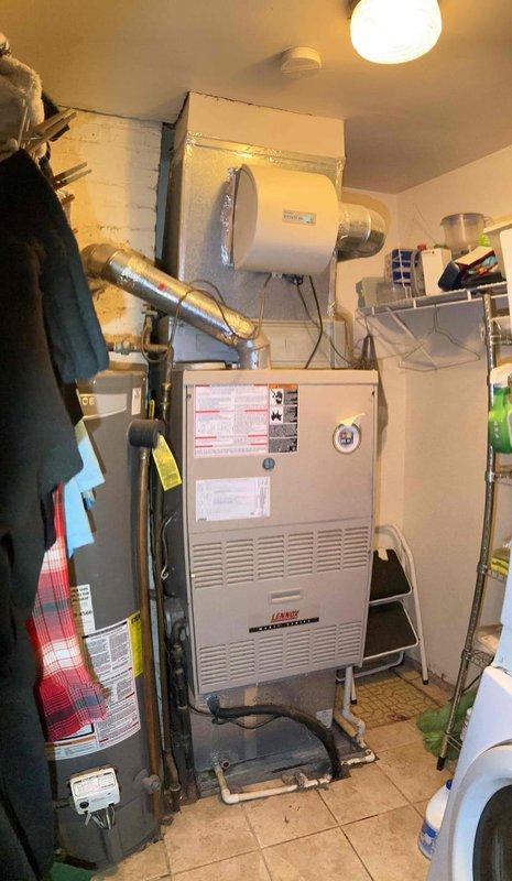 Performed a seasonal tune-up on a Lennox gas furnace located in a utility closet, including inspection of the furnace cabinet, flue venting, condensate/drain line, and plenum-mounted humidifier. Used a borescope inspection camera to visually examine the interior of the flexible duct and connected ductwork for obstructions or damage, and verified overall system condition for safe, efficient operation.