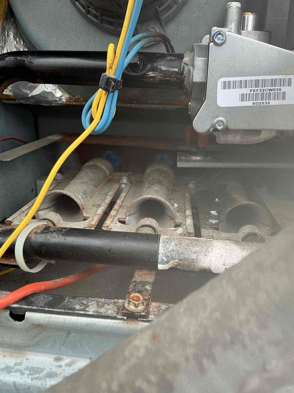 Replaced the failed gas valve on RTU #3, a Carrier packaged rooftop unit, and verified proper gas valve operation and burner ignition after installation. The burner compartment showed heavy corrosion, rust on the tray and brackets, and soot staining on the burner tubes, indicating aged components that may warrant further evaluation.
