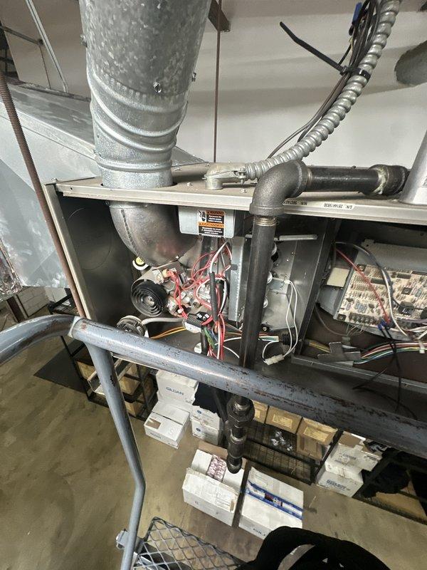 Responded to service call for dual-unit HVAC system where one unit was reported as non-operational. Performed diagnostic inspection on commercial rooftop gas furnace unit, accessing internal components including burner assembly, gas lines, and electrical wiring. Documented equipment condition and configuration for customer with active membership account.