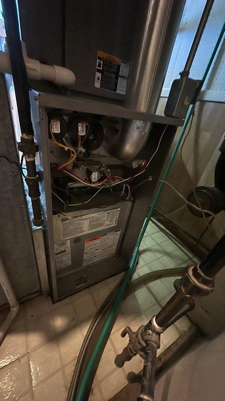 Responded to service call for furnace producing loud noise during startup cycle. Upon inspection, accessed internal components of vertical air handler unit and examined blower assembly, motor mounts, and electrical connections. Photographed existing equipment configuration including copper refrigerant lines, blower motors, and cabinet assembly for documentation purposes. Provided estimate for necessary repairs to resolve startup noise issue.