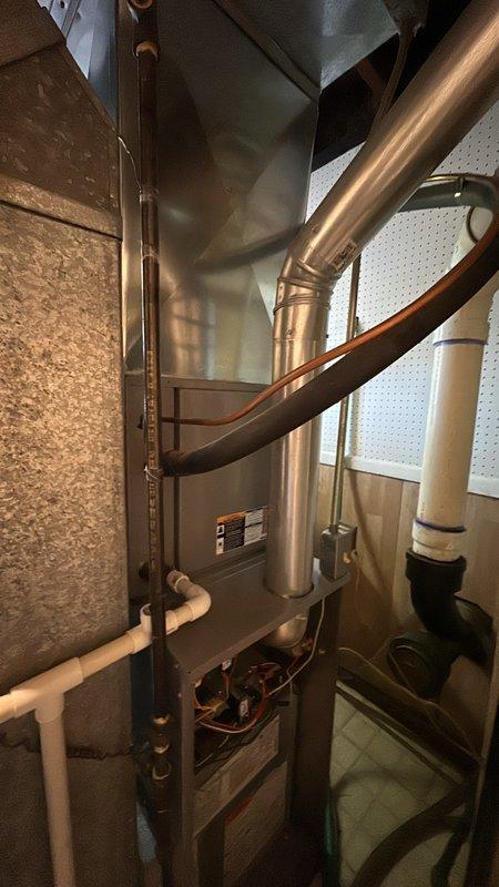 Responded to service call for furnace producing loud noise during startup cycle. Upon inspection, accessed internal components of vertical air handler unit and examined blower assembly, motor mounts, and electrical connections. Photographed existing equipment configuration including copper refrigerant lines, blower motors, and cabinet assembly for documentation purposes. Provided estimate for necessary repairs to resolve startup noise issue.