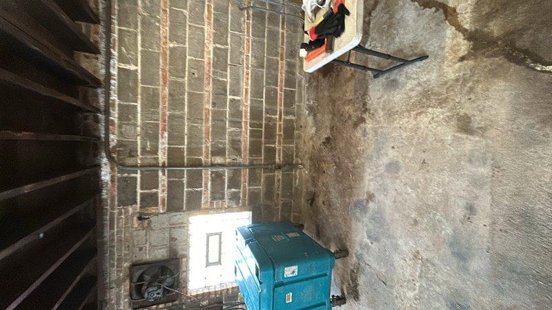 Conducted site assessment for quote amendment to incorporate exterior electrical outlets. Documented existing conditions including exterior service area with accessible wall space near waste receptacle location and basement utility room showing current electrical panel and infrastructure. Photographed proposed installation areas to facilitate accurate pricing for additional exterior outlet installation work.