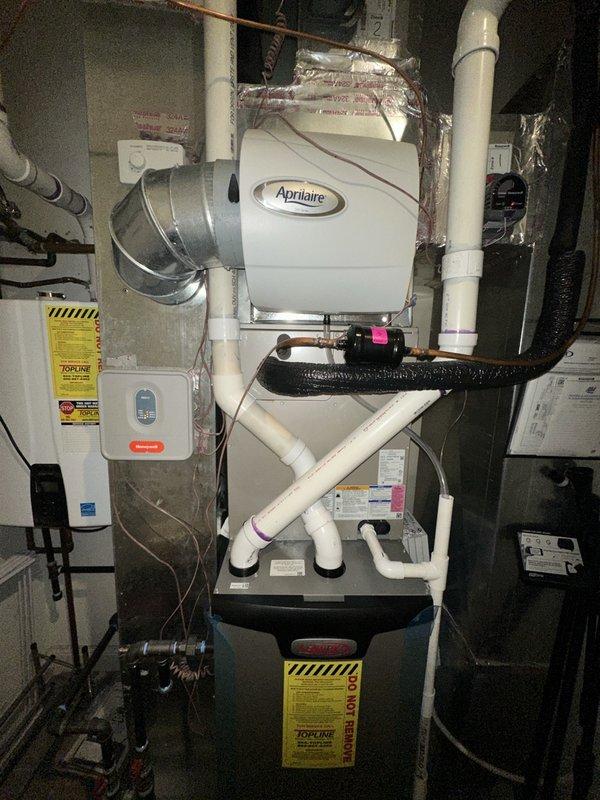 Completed preventive maintenance service on residential HVAC system. Performed thorough cleaning and inspection of outdoor AC condenser unit located on balcony, checked refrigerant lines and electrical connections. Inspected indoor equipment including furnace and Aprilaire humidifier system, verified proper operation of all components, cleared condensate drain lines, and confirmed system is operating within manufacturer specifications.