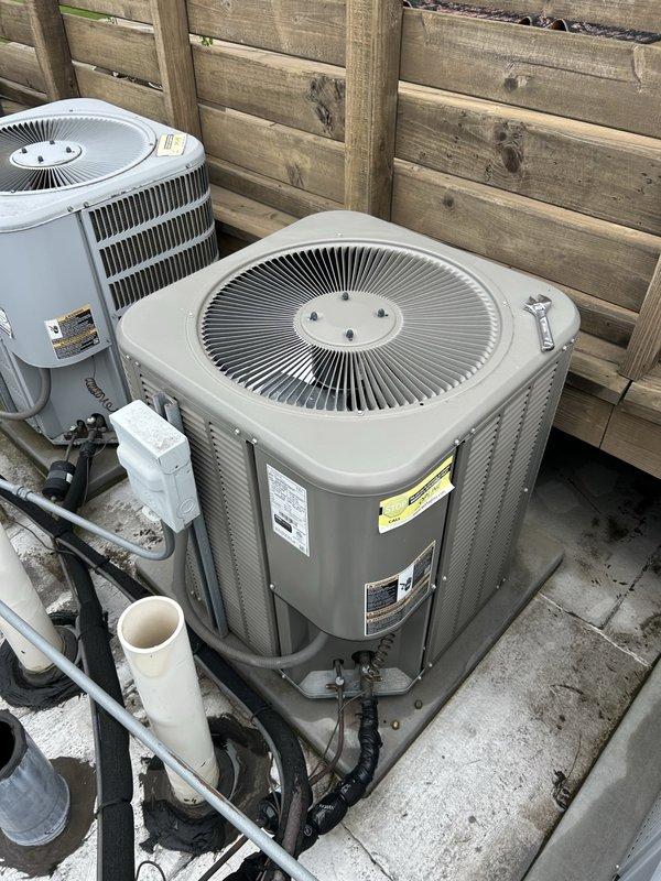 Responded to no cooling call with reported loud noise prior to system failure. Upon arrival, found dual outdoor condenser unit system with one unit inoperative. Diagnosed failed compressor and contactor on affected unit. Replaced faulty compressor, installed new contactor, and recharged system to manufacturer specifications. Verified proper operation of smart thermostat control and confirmed cooling cycle functioning normally. System restored to full operational capacity with both condenser units running quietly and efficiently.