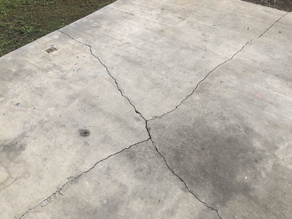 Exterior cracked concrete slab. Many times rebar isn’t used in exterior slabs. Concrete does two things, it gets hard and it cracks.