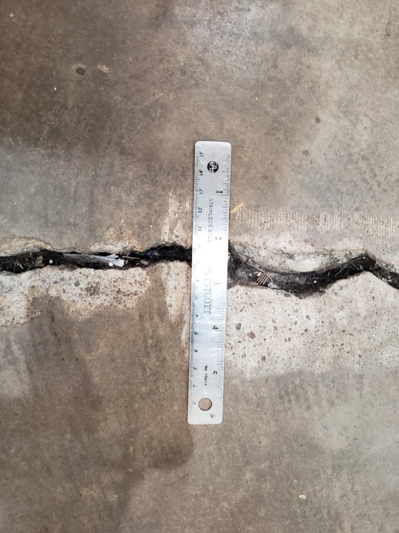 Foundation settlement with a 1" slab crack.