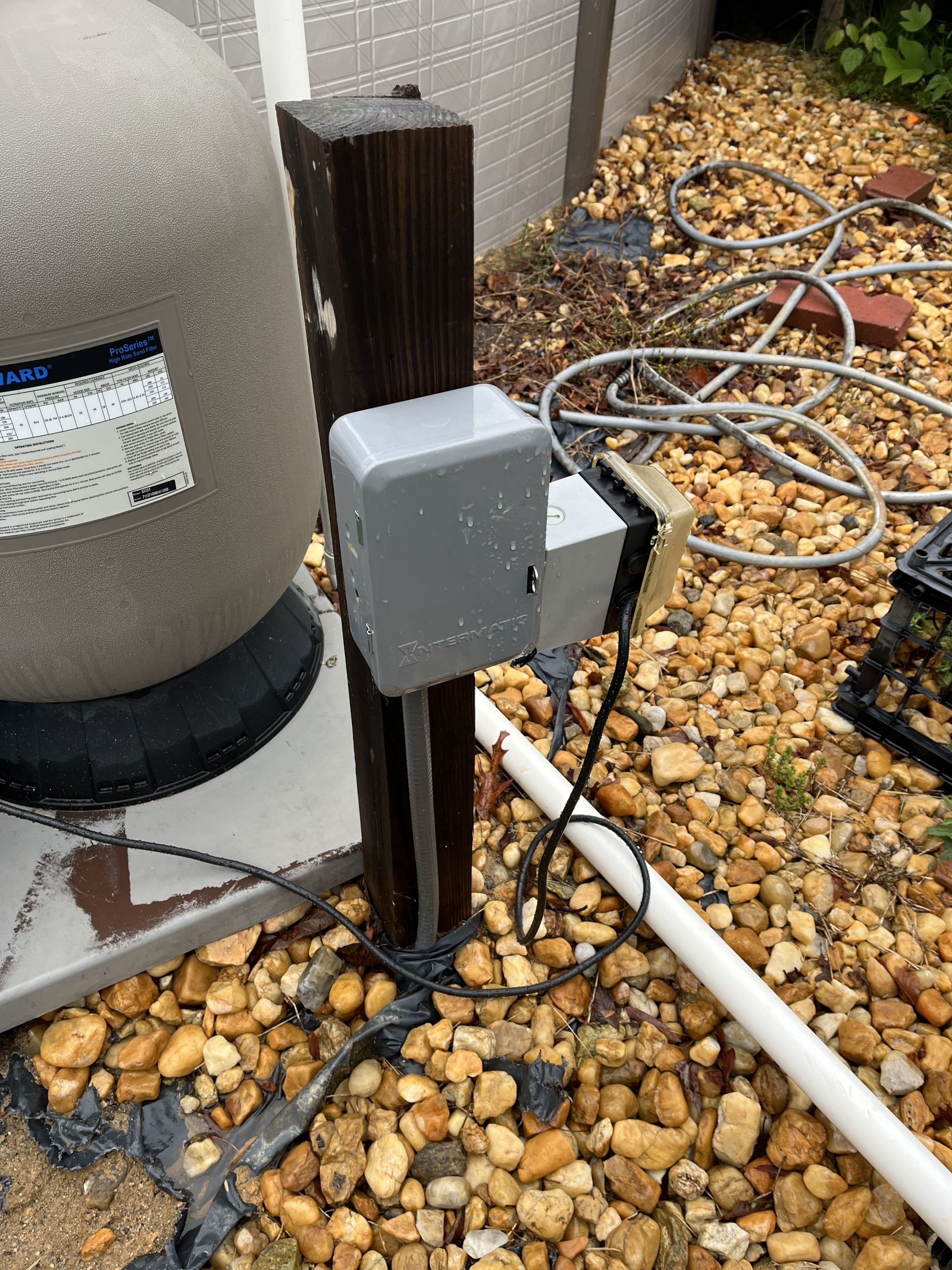 Removed a pool timer and installed new outdoor box and cover with new weather rated GFCI and switch to control pool equipment