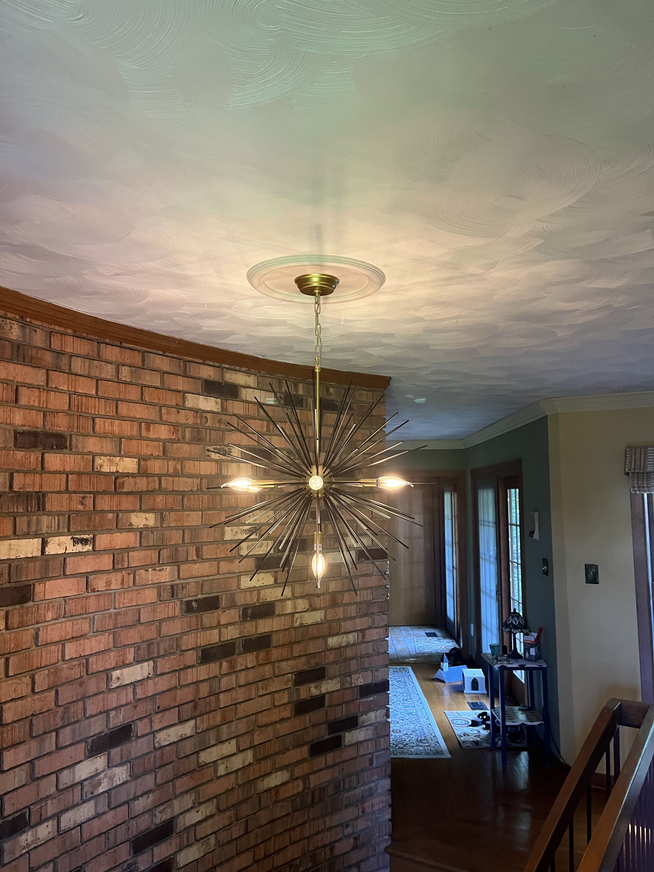 Installed new chandelier above a state case 