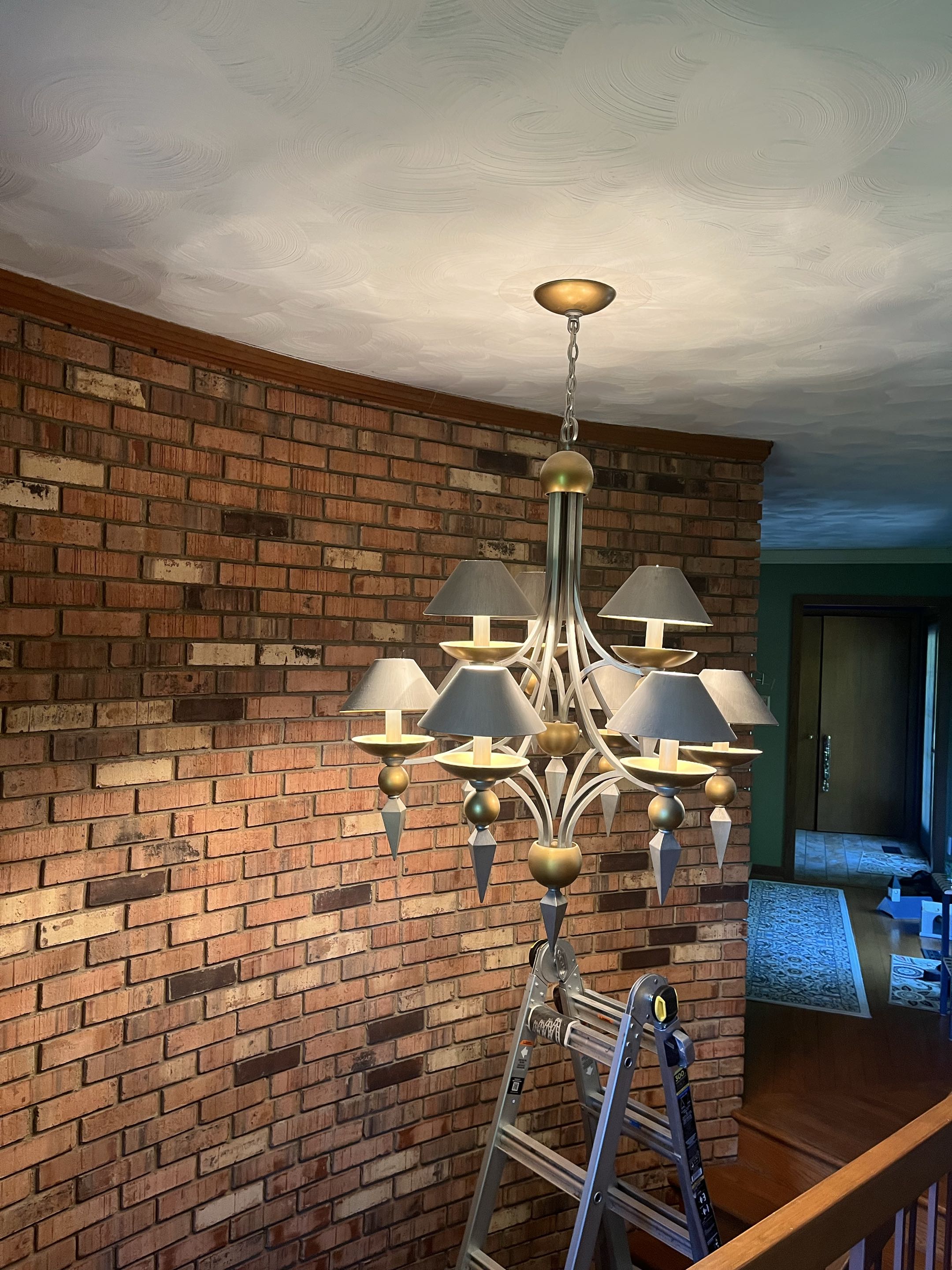 Installed new chandelier above a state case 