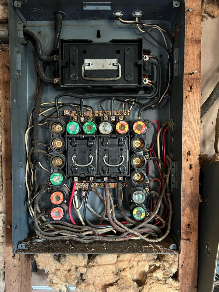Replace main electrical service, grounding system and fuse box with new 200 amp overhead service, circuit breaker panel and new wiring.  Relocate meter base and install disconnect.