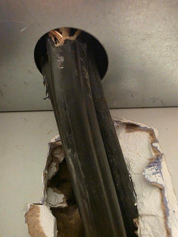 Responded to call back regarding improper installation of tankless water heater. Identified exposed electrical wires at bottom knockout of unit where installation crew had created rough hole through drywall without proper finishing or conduit protection. Properly secured electrical connections and repaired wall penetration to meet code requirements and ensure safe operation.