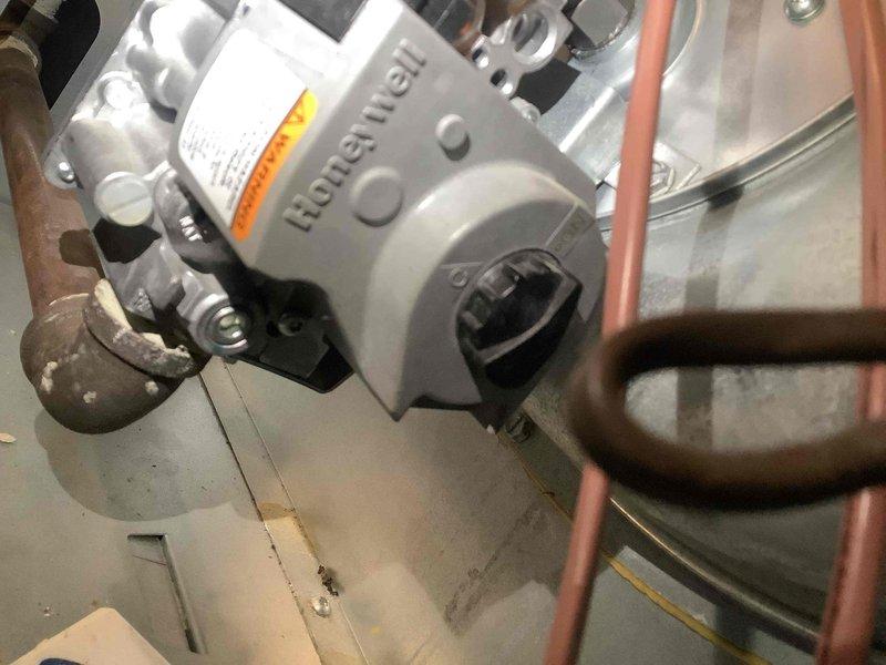 Inspected Honeywell gas valve on furnace that was failing to ignite despite gas presence. Found control knob was misaligned; reset valve, tested ignition sequence and confirmed proper operation. No gas leaks detected, burning smell resolved after repair.