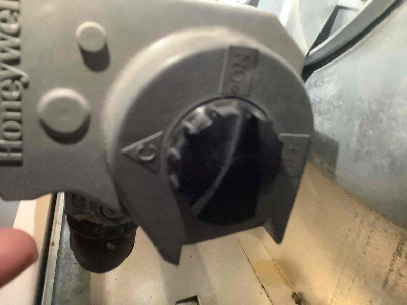 Inspected Honeywell gas valve on furnace that was failing to ignite despite gas presence. Found control knob was misaligned; reset valve, tested ignition sequence and confirmed proper operation. No gas leaks detected, burning smell resolved after repair.