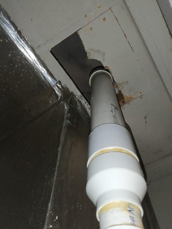 Diagnosed faulty internal Daikin drain trap in furnace requiring replacement under warranty. Unable to complete replacement due to incorrect part expectations (anticipated external p-trap replacement). Cut and added coupling to flu pipe section where previous improper installation had resulted in condensate leakage around silver tape.