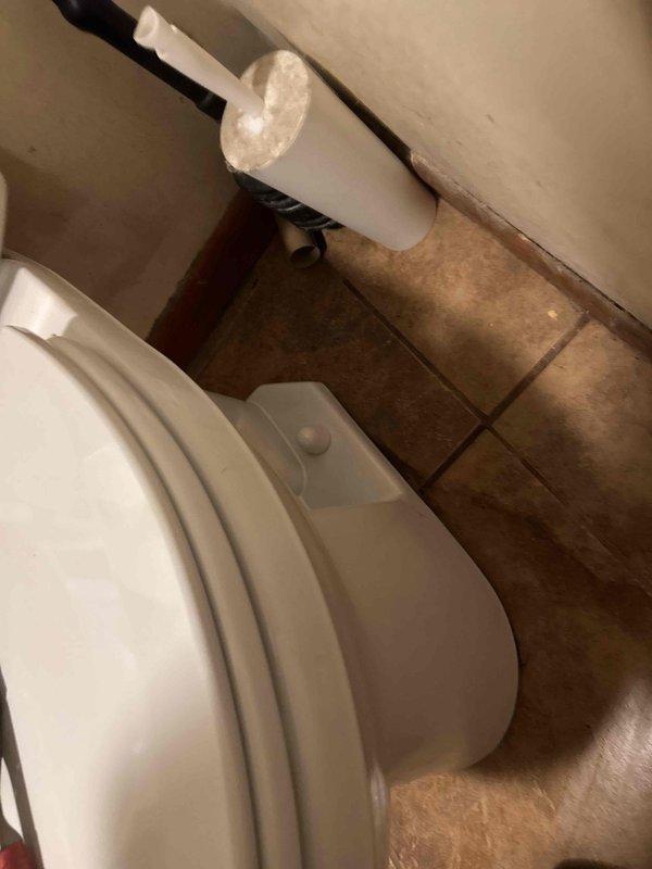 Completed toilet installation in residential bathroom, securing unit to tan ceramic tile flooring with proper seal. Installed and connected braided stainless steel water supply line to ensure proper functionality.