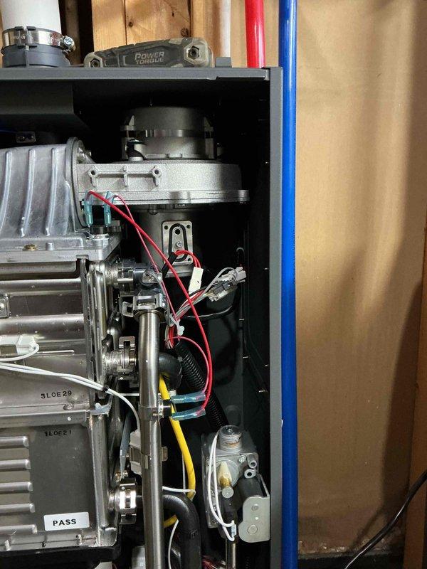 Successfully installed gas orifice on tankless water heater per warranty requirements. System was tested after installation and confirmed to be functioning properly. Documentation photos taken of completed work showing proper installation of all components.