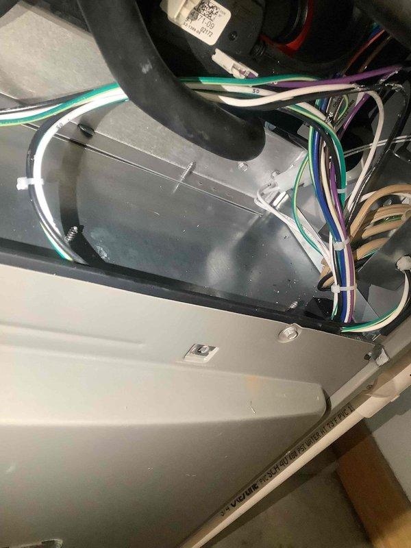 Responded to warranty call for leaking pipe and E155AE1 error code. Identified leaking condensate drain line and replaced damaged PVC section using proper adhesive at joints. Inspected electrical connections in unit, found loose wiring causing error code, and secured all connections. System now operating properly with no leaks or error codes.