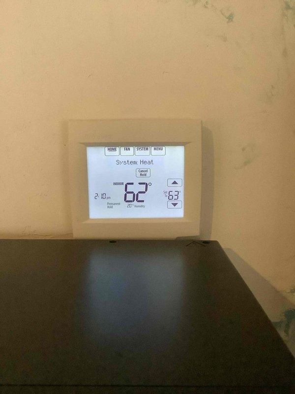 Performed comprehensive HVAC tune-up, inspecting and servicing the heating system which was set at 63°F with actual temperature reading 62°F. Examined the Honeywell Home ProSeries thermostat for proper operation and functionality, confirming system was operating in heat mode as appropriate for current conditions.
