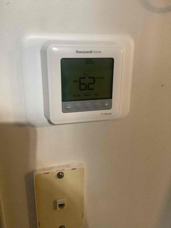 Performed comprehensive HVAC tune-up, inspecting and servicing the heating system which was set at 63°F with actual temperature reading 62°F. Examined the Honeywell Home ProSeries thermostat for proper operation and functionality, confirming system was operating in heat mode as appropriate for current conditions.