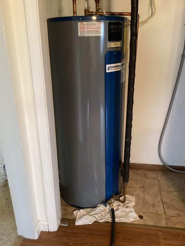 Performed diagnostic assessment of reported T&P valve leak on customer's Everhot tanked water heater. Inspected copper piping connections and valve assembly at top of unit. No active leaks were detected at the temperature and pressure relief valve or surrounding fittings. System appears to be operating normally with proper installation of discharge tube.
