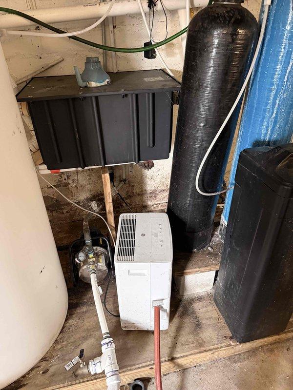 Conducted a comprehensive evaluation of an aging water softener system with dual tanks (black and blue) as requested by customer. Upon inspection, identified the system as functioning properly despite its age, with no immediate repairs needed. Verified proper operation of control panels, connections, and checked for any leaks in the surrounding plumbing infrastructure. Customer was advised on expected remaining lifespan and potential future maintenance requirements.