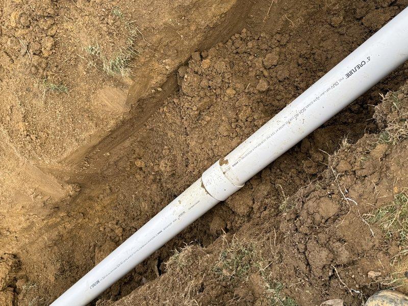 Excavated trench and replaced main drain line with new PVC piping, successfully installing a cleanout access point as requested. Additionally, installed customer-provided toilet that was not on the original invoice. RC performed excavation work to access the drain line.
