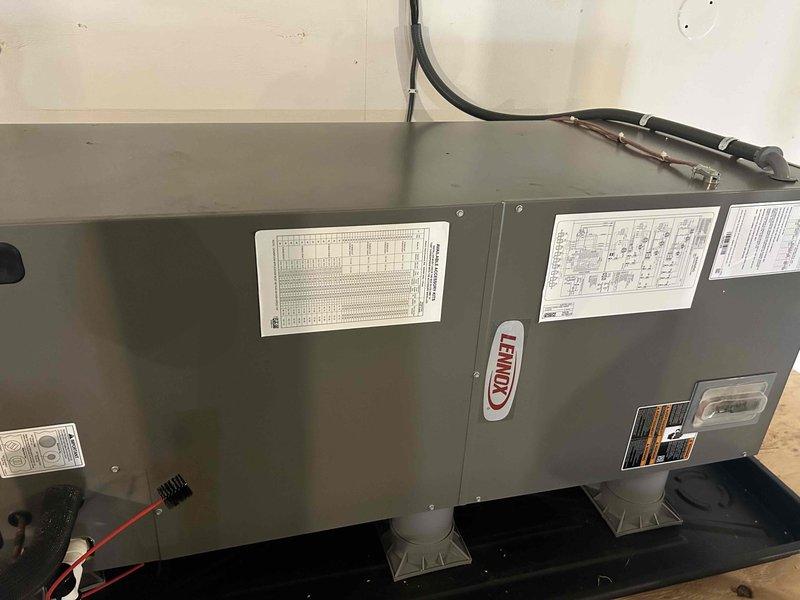 Completed installation of Lennox HVAC system for garage area, including indoor air handler unit mounted on plastic supports and outdoor condensing unit properly positioned on gravel bed with concrete pad. System was fully connected with appropriate electrical wiring and refrigerant lines, then successfully started up and tested for optimal performance.