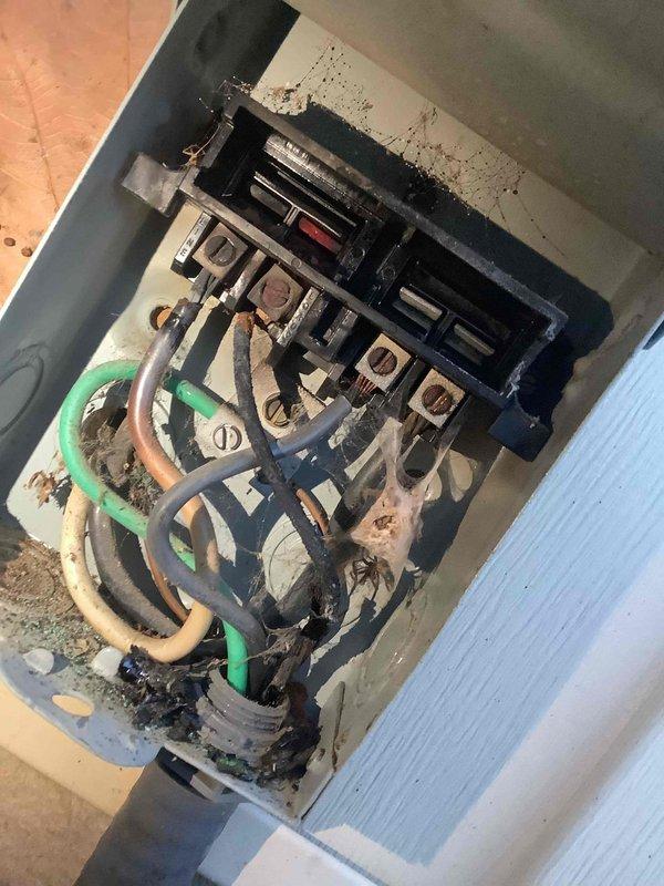 Responded to no heat call and found thermostat without power. Inspection revealed severely deteriorated electrical connections in the junction box with visible corrosion, burn marks, and compromised wire insulation. Electrical panel showed signs of aging with disorganized wiring that posed significant safety hazards.