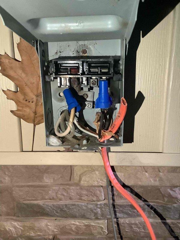 Responded to no heat call and found thermostat without power. Inspection revealed severely deteriorated electrical connections in the junction box with visible corrosion, burn marks, and compromised wire insulation. Electrical panel showed signs of aging with disorganized wiring that posed significant safety hazards.