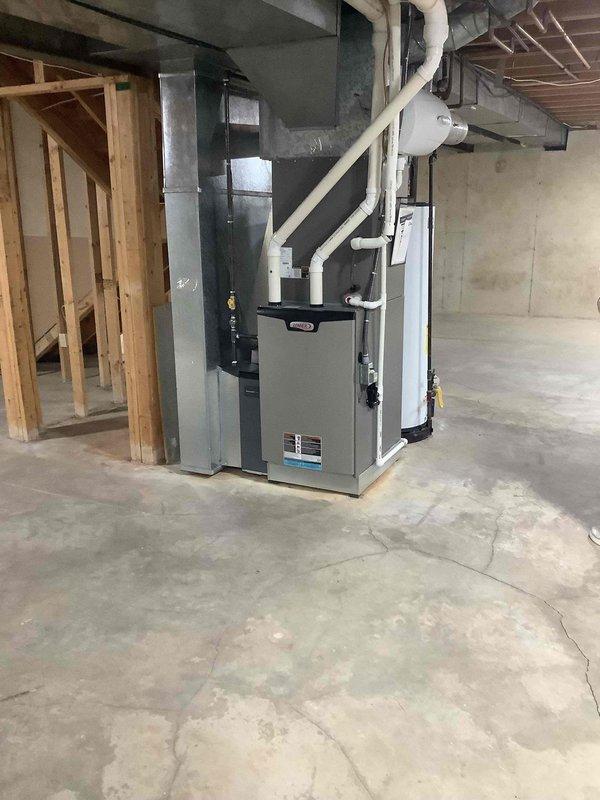 Inspected furnace system in basement following home inspector's report of a leak in connection. Evaluated PVC drainage pipes and ventilation connections to furnace. No active leaks observed during inspection. System appears to be in normal operating condition with proper connections to ductwork and venting.