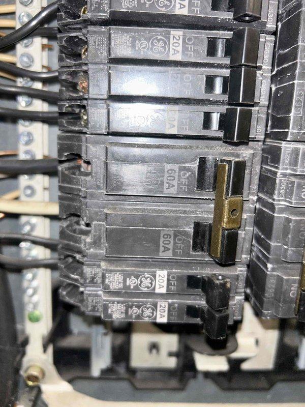 Inspected electrical panel to diagnose no heat issue in aging HVAC system. Found and inspected multiple circuit breakers including 20A and 60A units, verifying proper electrical supply to heating equipment. Confirmed all connections were secure with no visible damage to wiring.