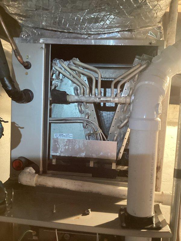 Performed routine heating maintenance on customer's furnace system. Inspected interior components including copper lines, connections, and PVC venting. All equipment appeared in normal working condition with no issues identified in both the furnace unit and adjacent water heater setup.