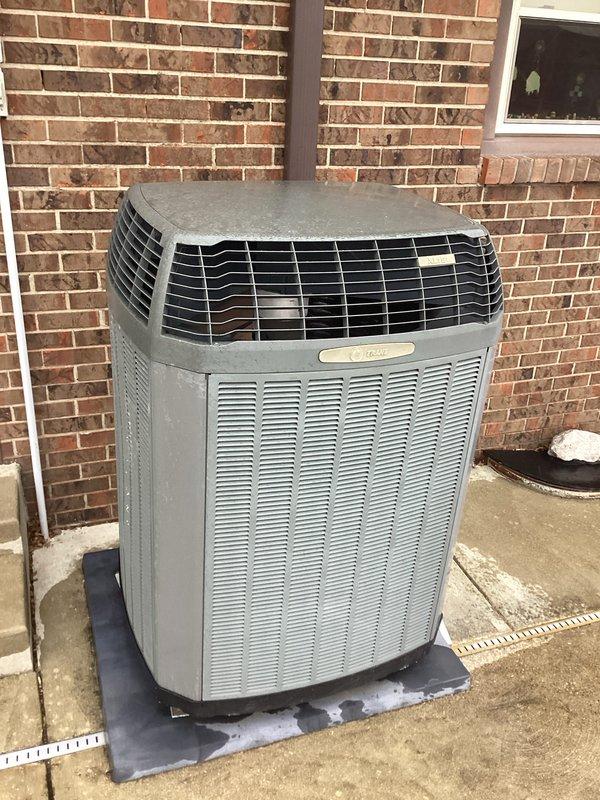 Performed routine maintenance on dual-system heating setup including outdoor heat pump and programmable thermostat. Inspected primary unit components, verified proper operation with thermostat showing room temperature of 73° and outside temperature of 38°. Both systems functioning correctly after addressing customer's concern about unusual heating behavior.