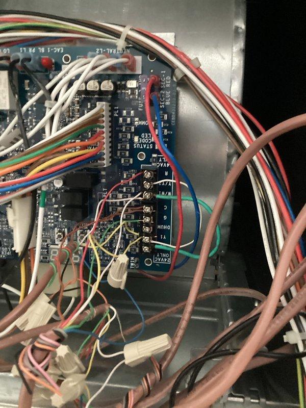 Returned to complete wiring installation for outdoor temperature sensor and configured zone 2 heating controls for proper 1st and 2nd stage operation. Successfully connected all required wiring to the control board terminals and verified proper system functionality of the Tempstar furnace system.