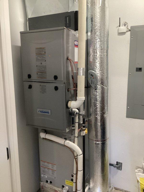 Returned to complete wiring installation for outdoor temperature sensor and configured zone 2 heating controls for proper 1st and 2nd stage operation. Successfully connected all required wiring to the control board terminals and verified proper system functionality of the Tempstar furnace system.