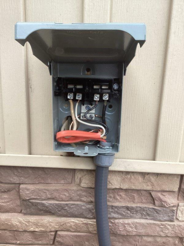Completed installation of electrical disconnect box on exterior vinyl siding wall, properly connecting all wiring with appropriate connectors and weatherproof housing. Connected system to main electrical panel, ensuring proper circuit integration for safe HVAC operation.
