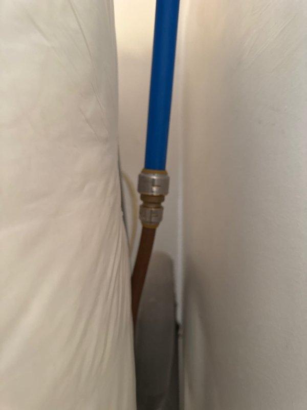 Successfully installed a new tanked water heater system, connecting PEX tubing to copper supply lines with proper compression fittings. Applied insulation blanket to top of unit to improve energy efficiency and reduce heat loss. All connections were secured and system was verified operational with proper drainage pan in place.
