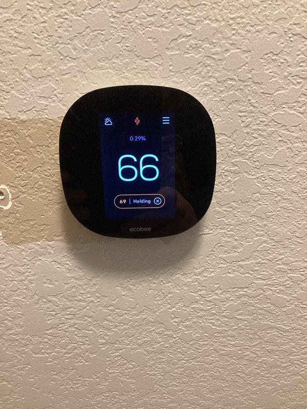 Responded to call for furnace running constantly on emergency heat mode. Inspected system and found low battery (25%) on ecobee thermostat potentially contributing to control issues. Installed new 20x20x4 FilterBuy air filter to ensure proper airflow and system efficiency. System now operating normally with proper heating cycle engagement.
